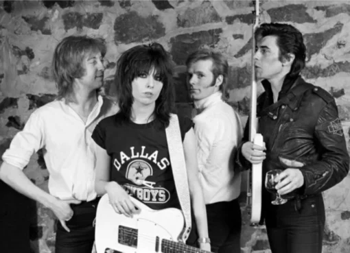 Close-up shot of Chrissie Hynde with dark eye makeup and a serious expression, embodying a punk rock aesthetic.