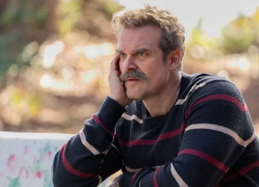 David Harbour holding his Emmy award.