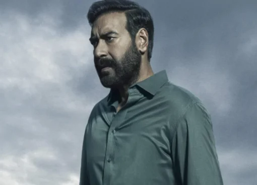 Ajay Devgn as Vijay Salgaonkar looking serious in a dark, mysterious scene from Drishyam: The Conclusion trailer.