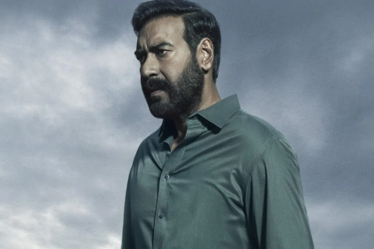 Ajay Devgn as Vijay Salgaonkar looking serious in a dark, mysterious scene from Drishyam: The Conclusion trailer.