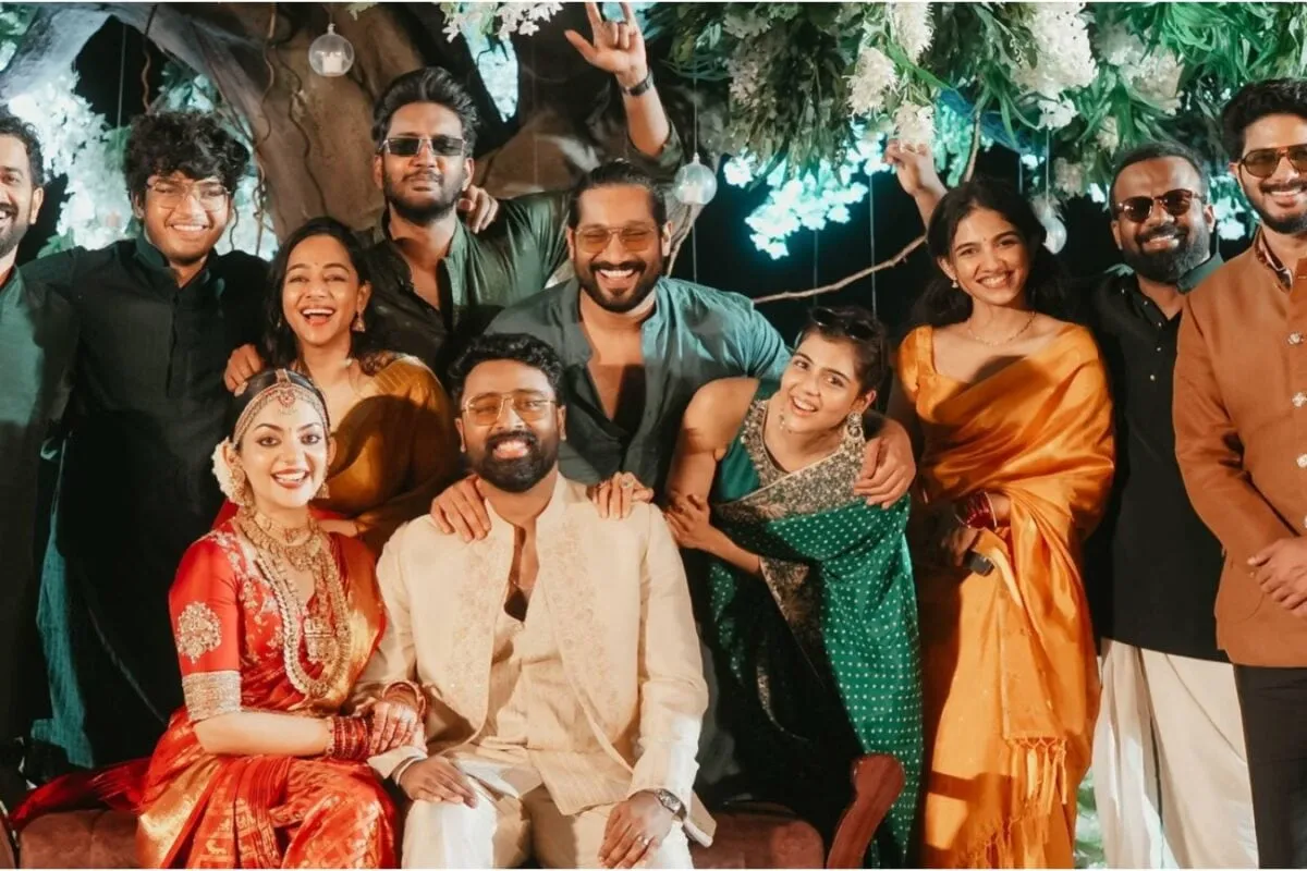Dulquer Salmaan, Kalyani Priyadarshan, Mamitha Baiju and the Lokah team smiling and celebrating at Ahaana Krishna and Nimish Ravi's wedding.