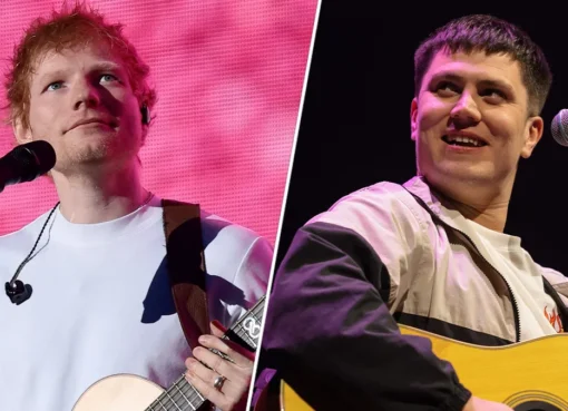 Singer Ed Sheeran performing on stage with guitar.