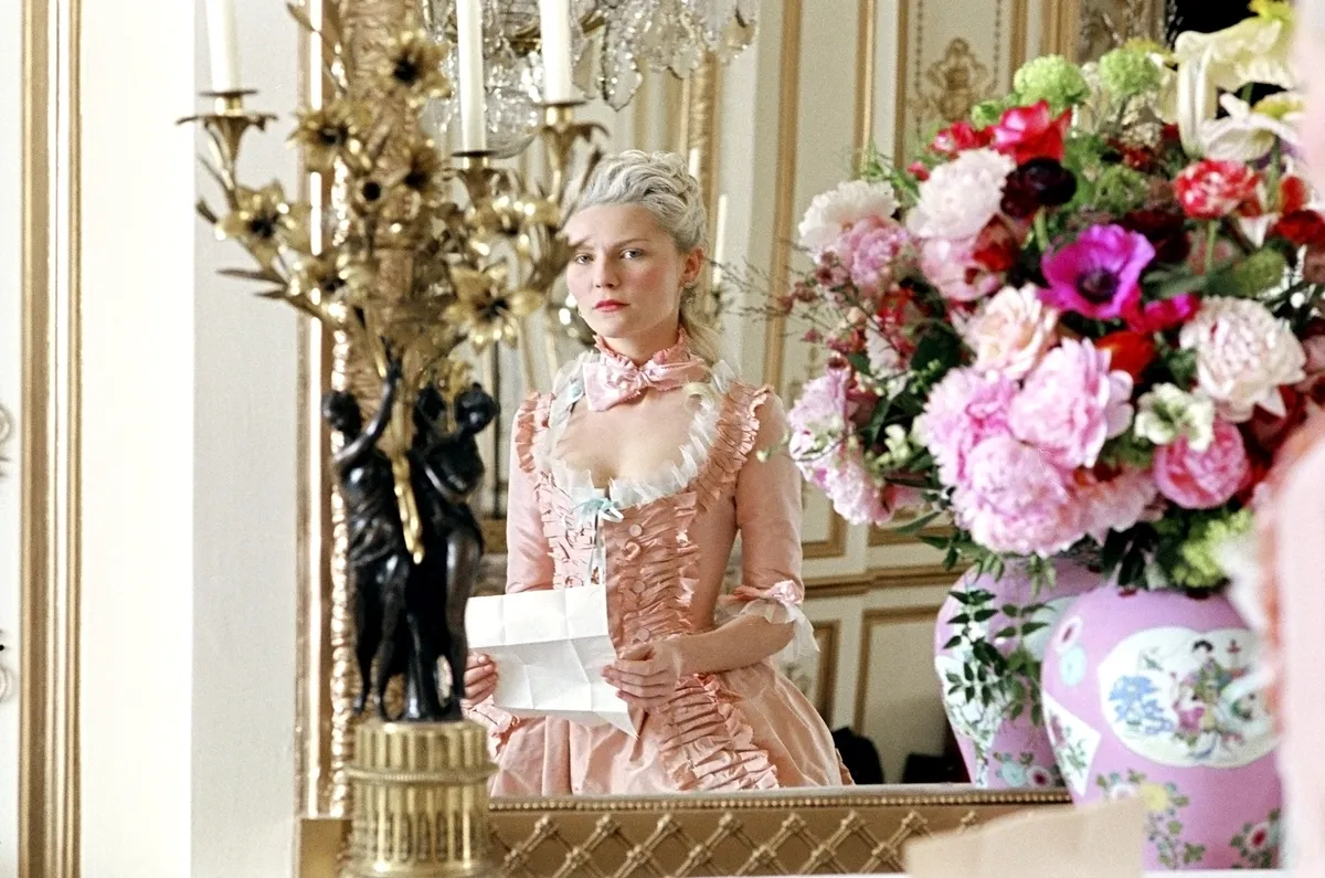 A still image from the documentary showing Eleanor Coppola observing a film set.