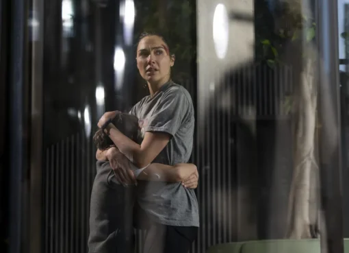 Gal Gadot looking determined and running on a London street.