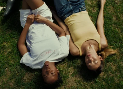 Promotional poster for the movie Sunburn, showing a sunny, community-focused scene.
