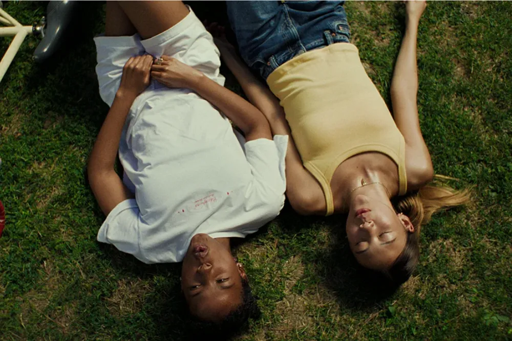 Promotional poster for the movie Sunburn, showing a sunny, community-focused scene.