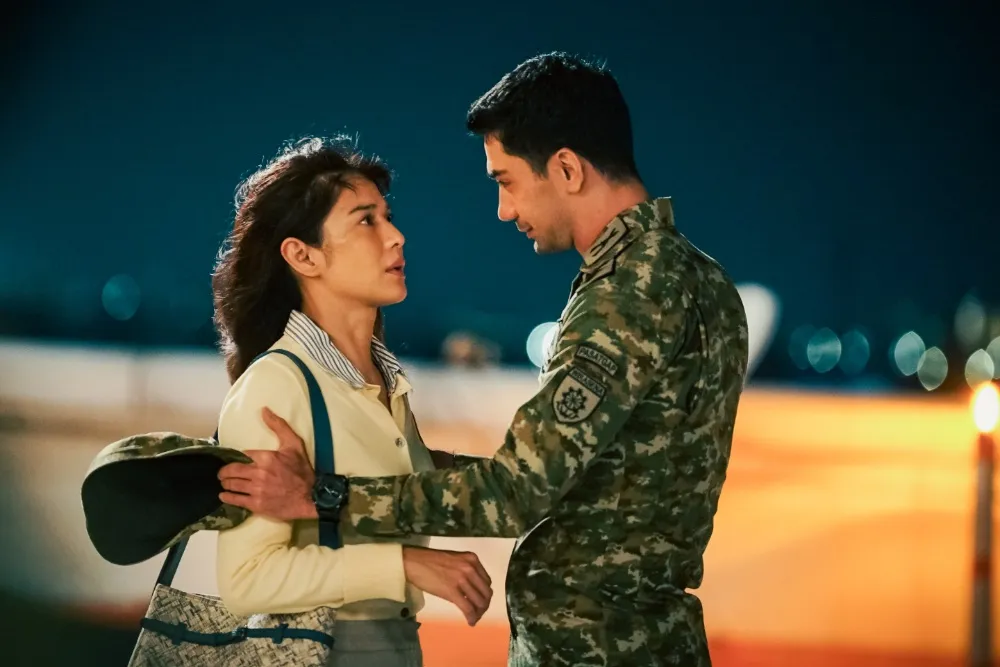 Promotional image for 'Descendants of the Sun' movie with actors Reza Rahadian and Dian Sastrowardoyo looking dramatically at each other.