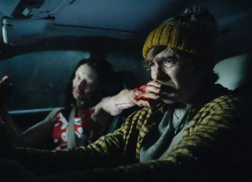 A dark, intense scene from the 'Resident Evil' movie with a zombie or action sequence.