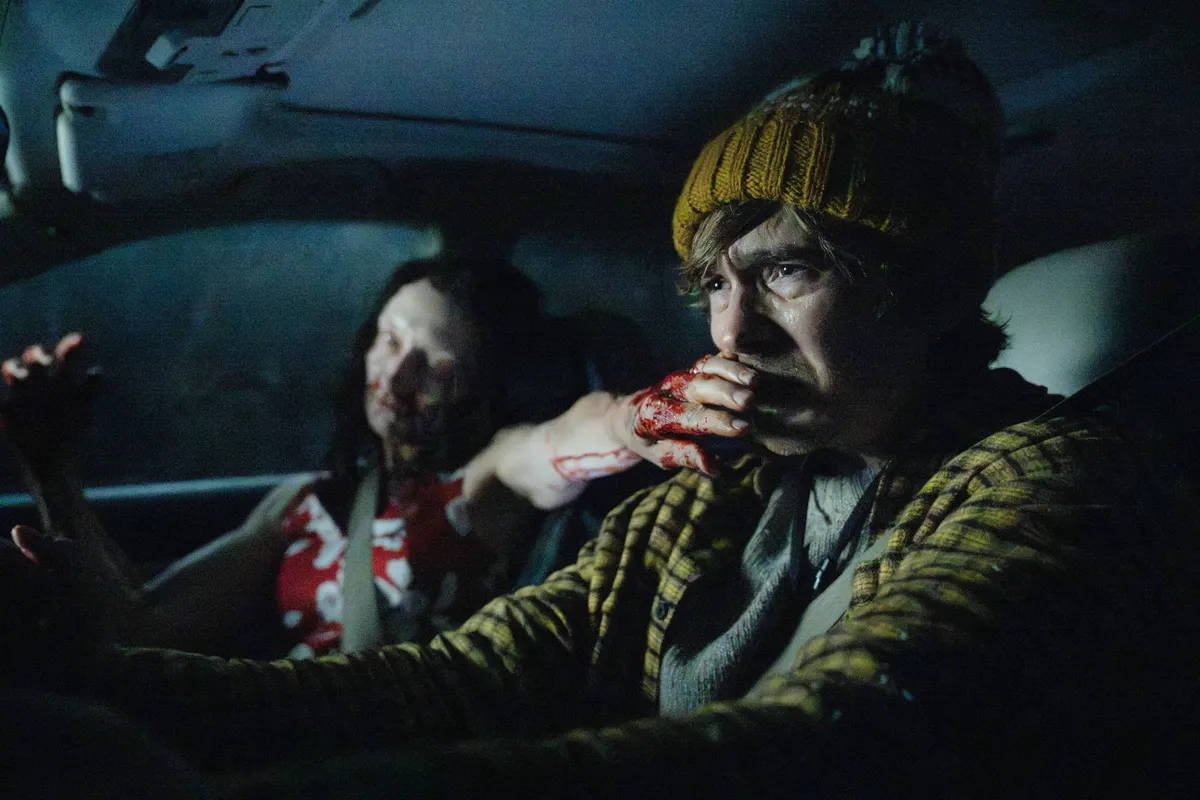 A dark, intense scene from the 'Resident Evil' movie with a zombie or action sequence.