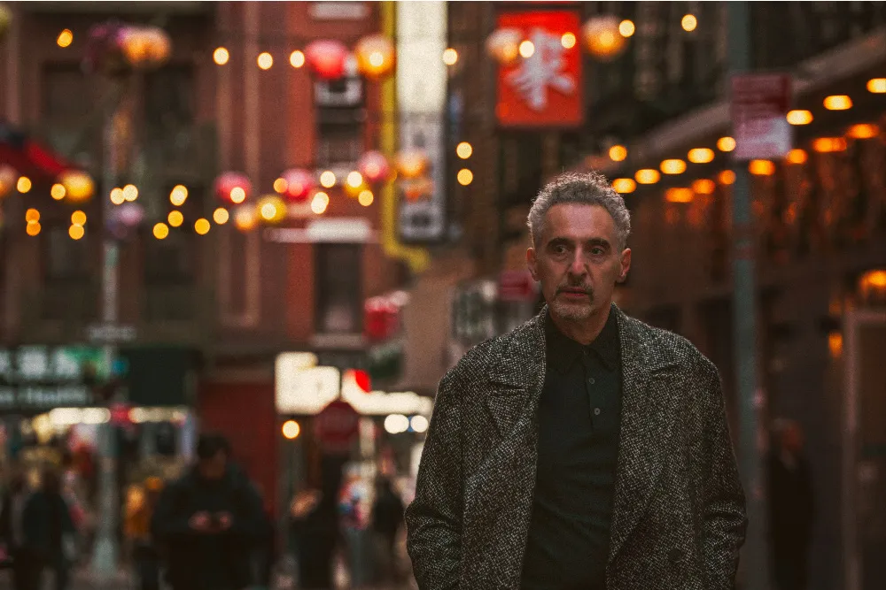 Actor John Turturro looking thoughtful at a film event.