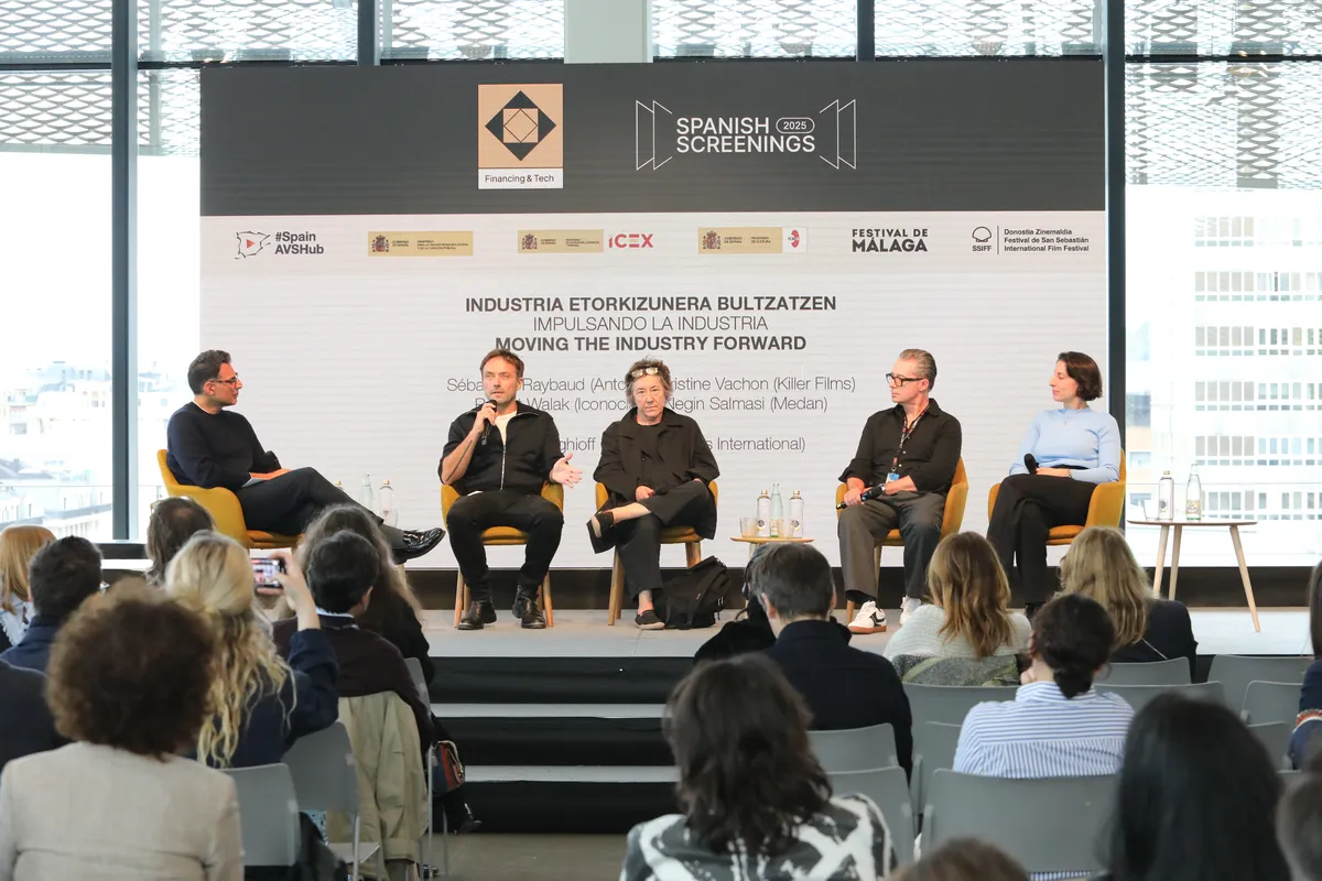 A diverse group of film industry leaders and investors gathered at a modern conference, discussing projects.