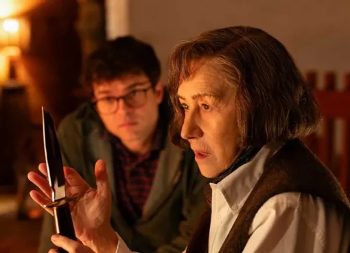 Helen Mirren portraying Patricia Highsmith, looking stern and intense.