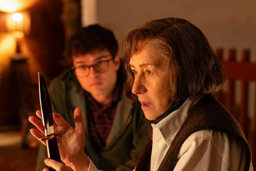 Helen Mirren portraying Patricia Highsmith, looking stern and intense.