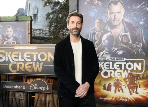Jon Watts smiling at an event.