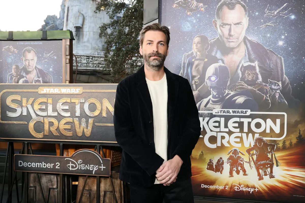 Jon Watts smiling at an event.