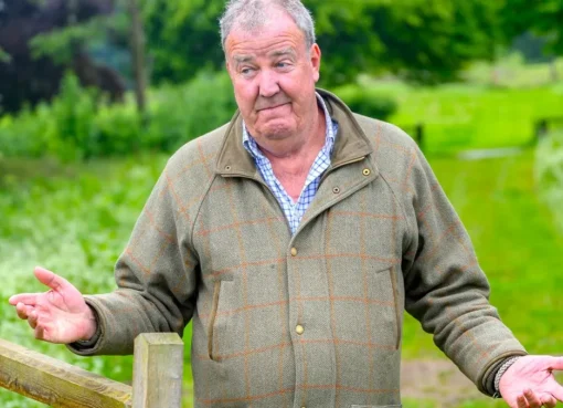 Jeremy Clarkson looking thoughtful on his farm, possibly with a tractor in the background.