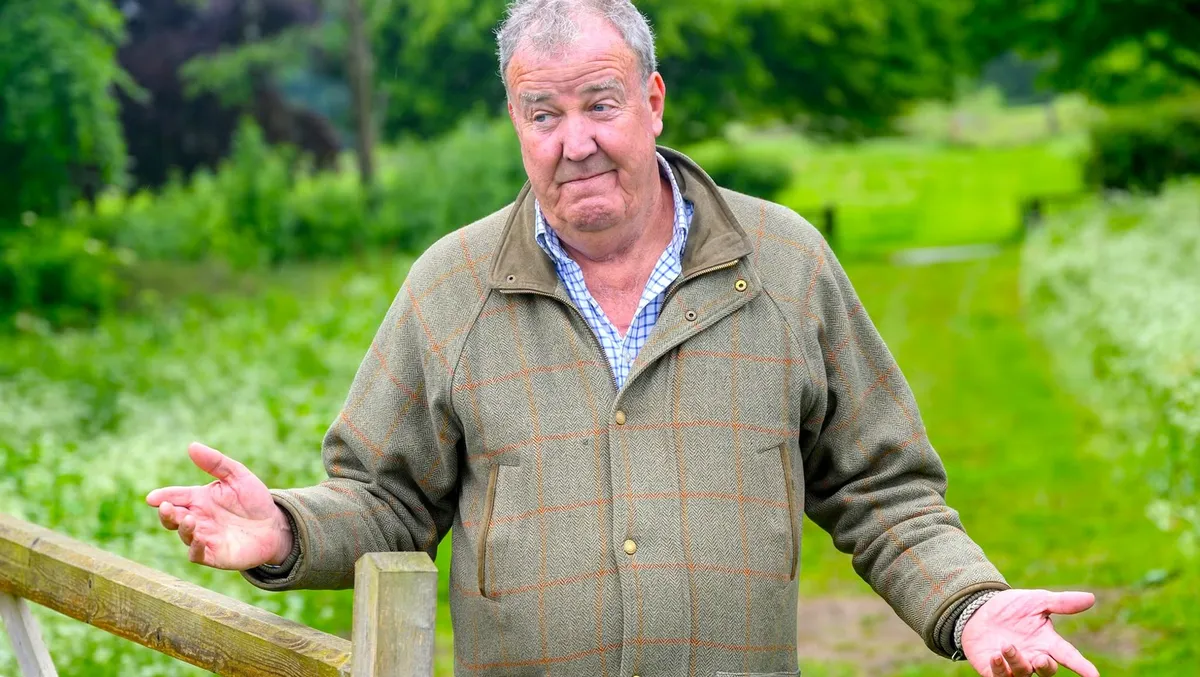 Jeremy Clarkson looking thoughtful on his farm, possibly with a tractor in the background.