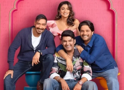Akshay Kumar and Kapil Sharma laughing on the set of The Great Indian Kapil Show, with Drishyam 3 team members nearby.