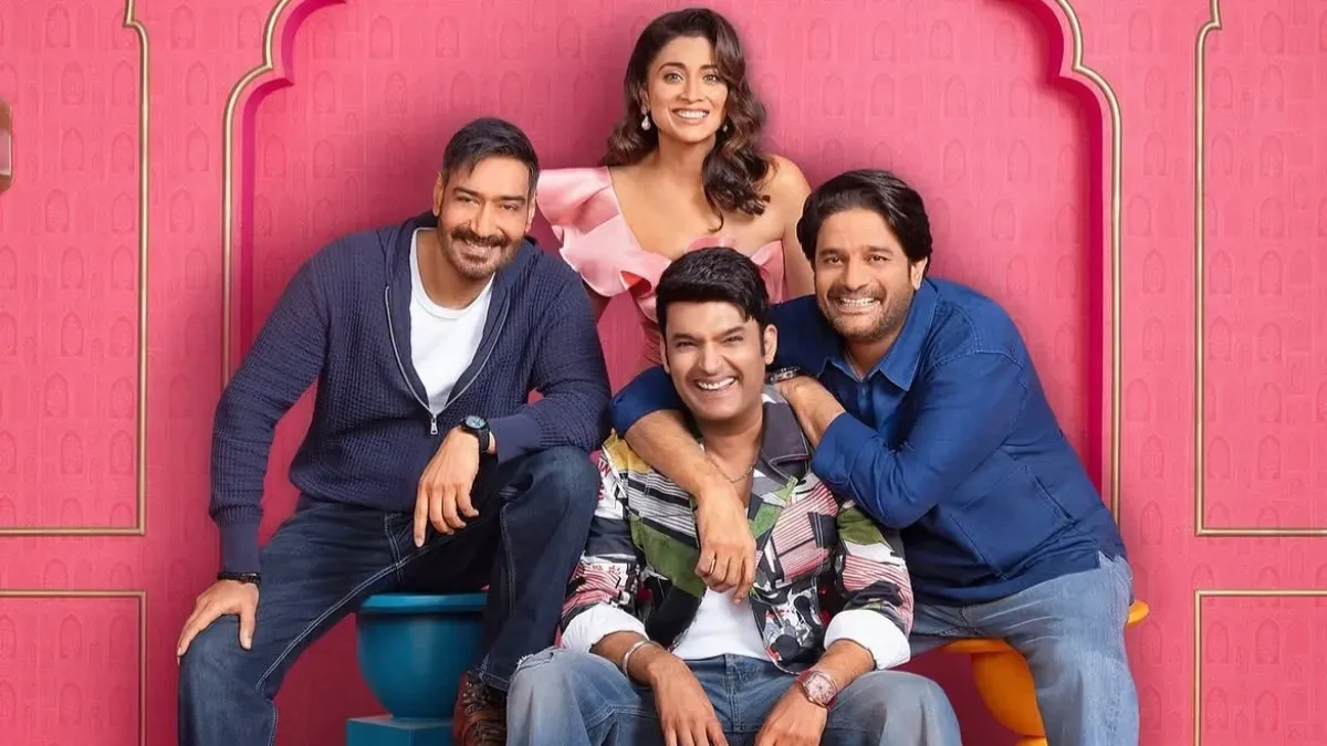 Akshay Kumar and Kapil Sharma laughing on the set of The Great Indian Kapil Show, with Drishyam 3 team members nearby.