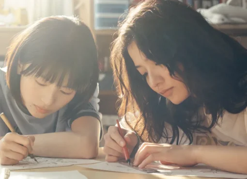 Two young girls, main characters from 'Look Back', looking serious and determined.