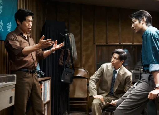 A movie poster for 'The Assassin(s)' featuring a serious-looking character, with text in Korean and English, hinting at a political crime thriller.