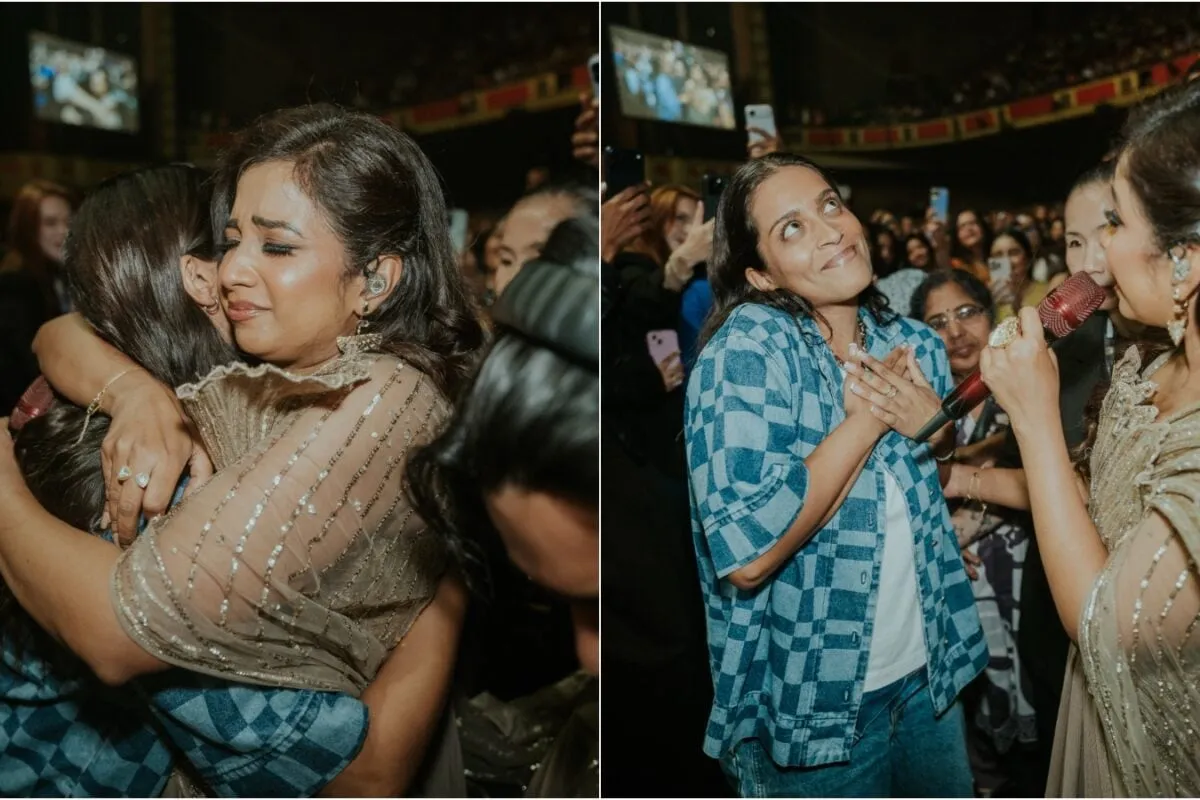 Lilly Singh smiling brightly next to singer Shreya Ghoshal backstage at a concert.