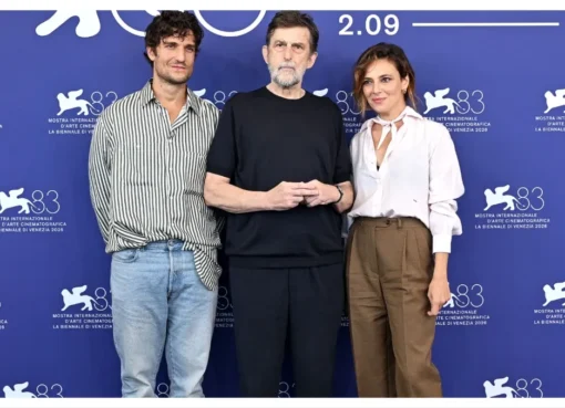 Louis Garrel smiling at a press conference, possibly for the film 'It Will Happen Tonight'.