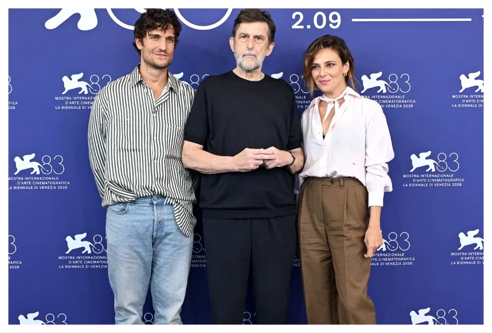 Louis Garrel smiling at a press conference, possibly for the film 'It Will Happen Tonight'.
