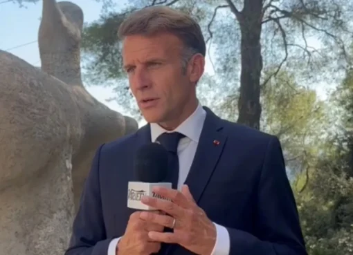 French President Emmanuel Macron speaking at a summit, looking serious.