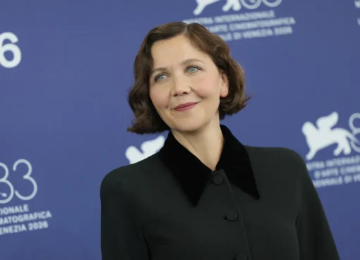 Maggie Gyllenhaal smiling at a film festival.