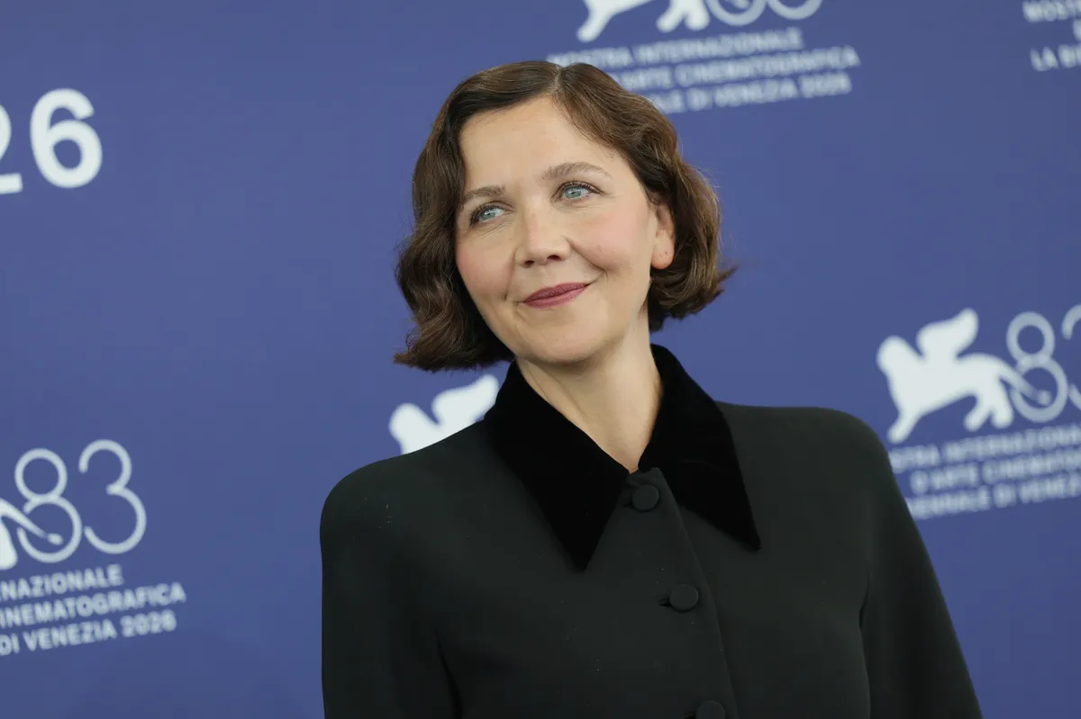 Maggie Gyllenhaal smiling at a film festival.