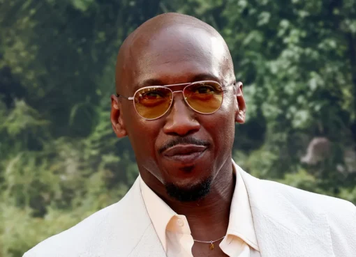 A close-up shot of Mahershala Ali looking thoughtful with a serious expression.