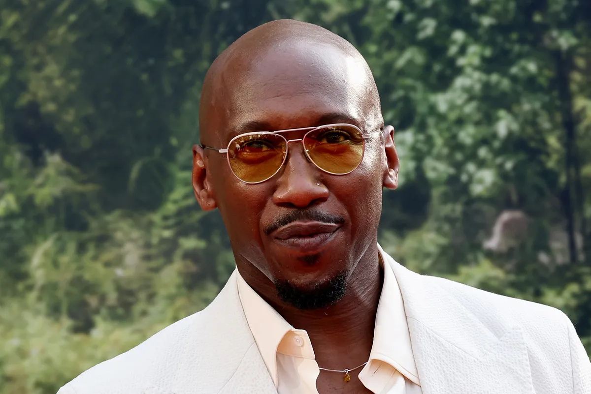 A close-up shot of Mahershala Ali looking thoughtful with a serious expression.