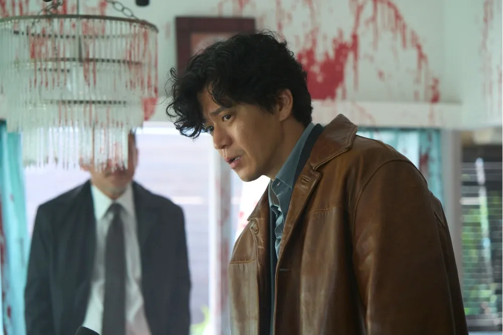 A dark, atmospheric scene from 'Bad Lieutenant: Tokyo' showing a character in a gritty Tokyo street.