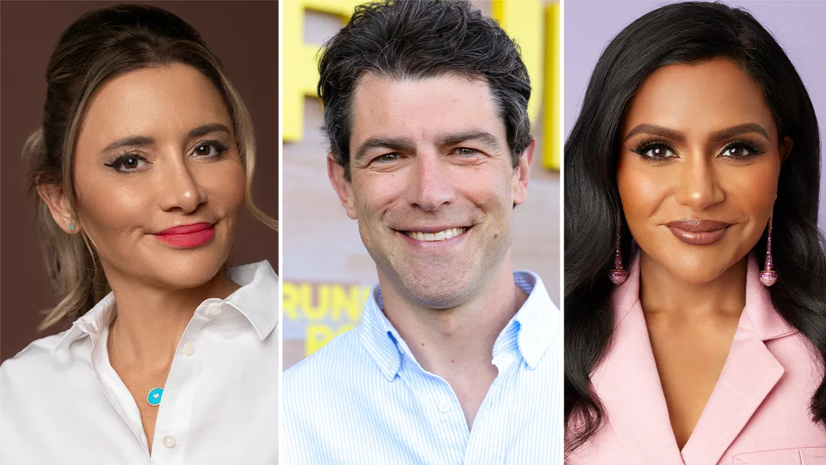 Mindy Kaling and Max Greenfield smiling and looking excited.