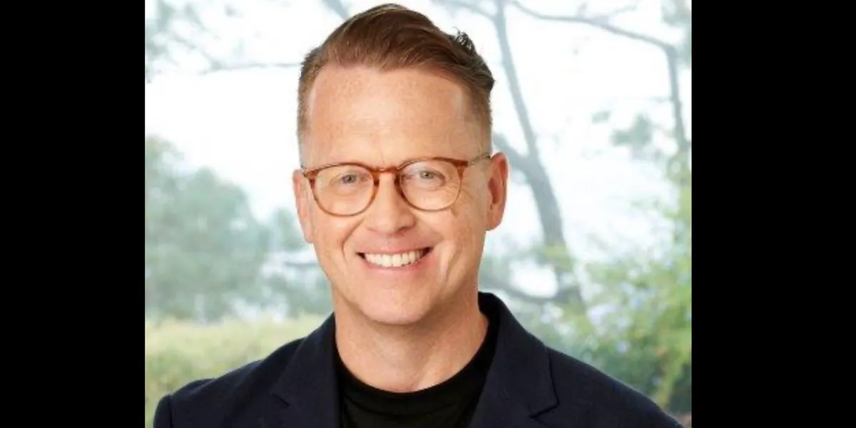 Noel Hedges smiling in a professional setting.