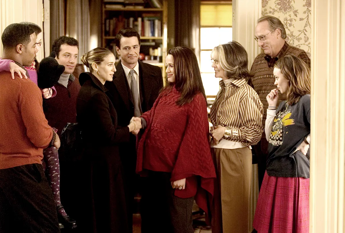 The ensemble cast of The Family Stone smiling together in a festive, cozy setting.