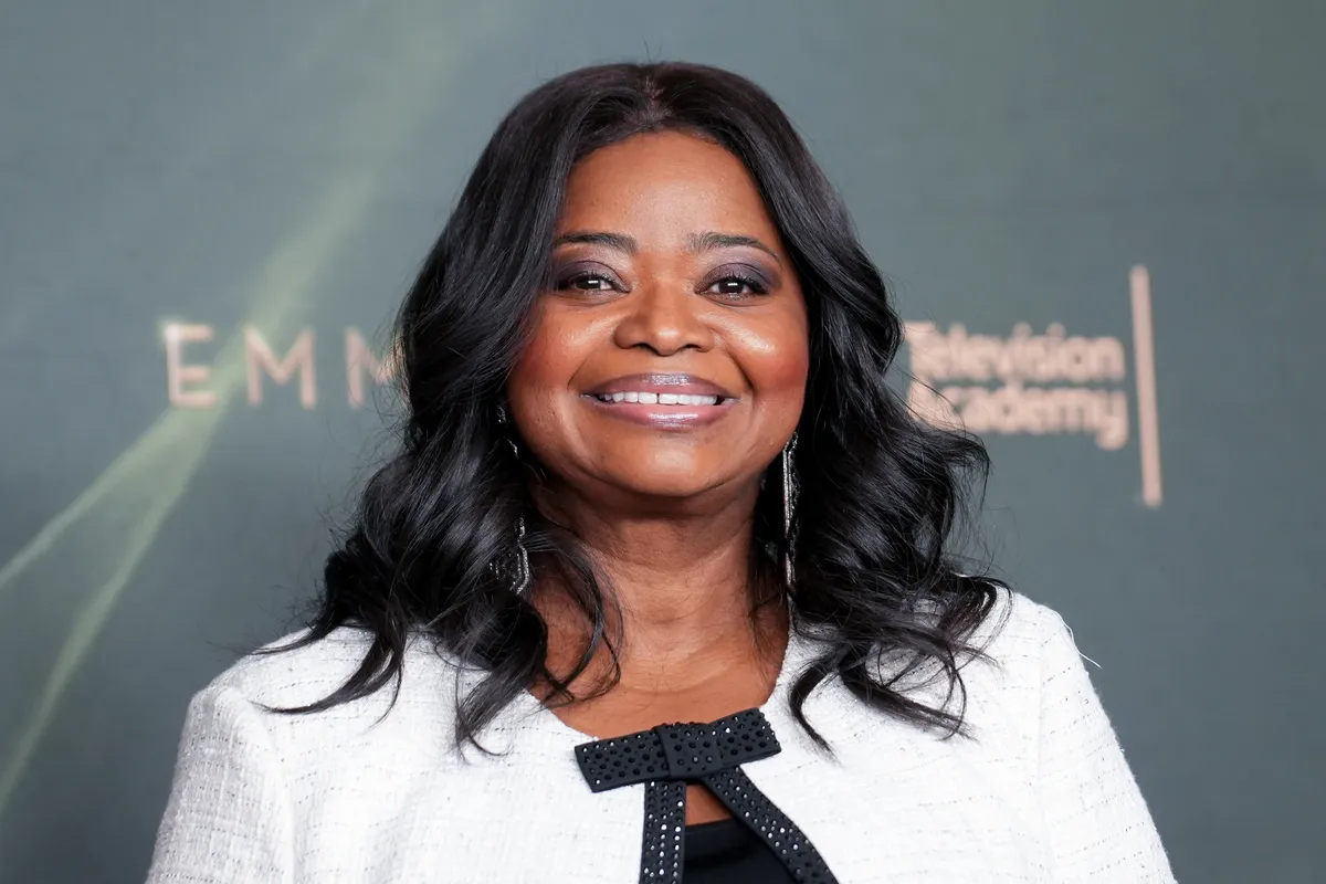 Octavia Spencer holding her Emmy award.