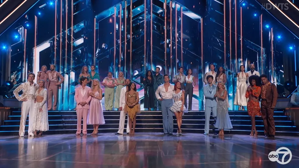 A group of dancers on a ballroom stage.
