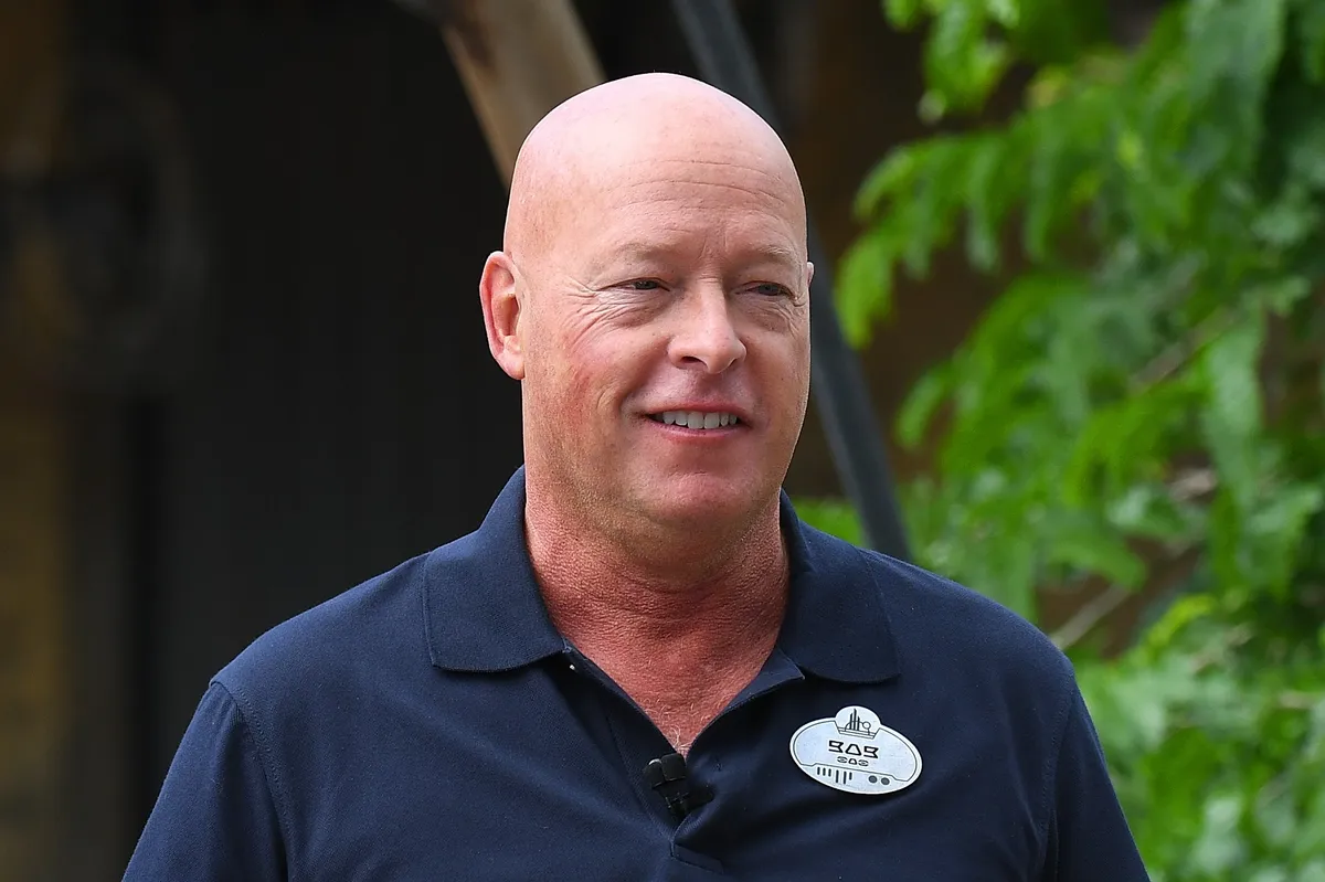 Bob Chapek looking serious, possibly with a Disney castle in the background.