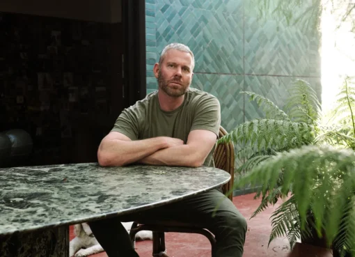 Richard Christiansen of Flamingo Estate in a natural, sunlit setting, possibly holding a product.