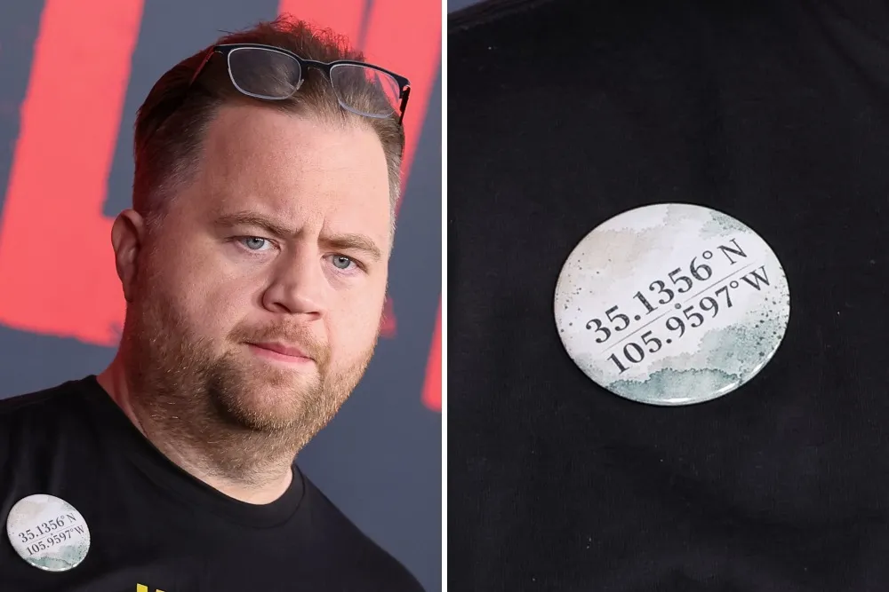 Paul Walter Hauser wearing a black T-shirt with a small pin featuring numbers.