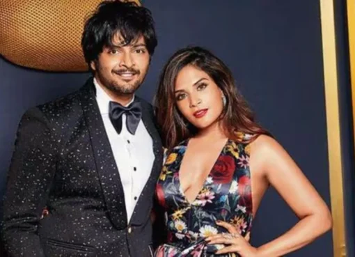 Richa Chadha and Ali Fazal smiling together at a movie premiere