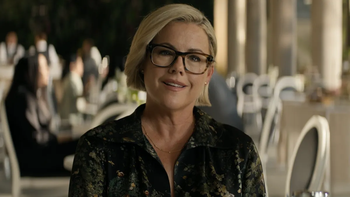 Kathleen Robertson smiling, possibly in a professional setting.