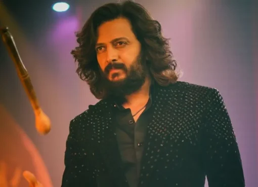 Riteish Deshmukh smiling and talking to the media
