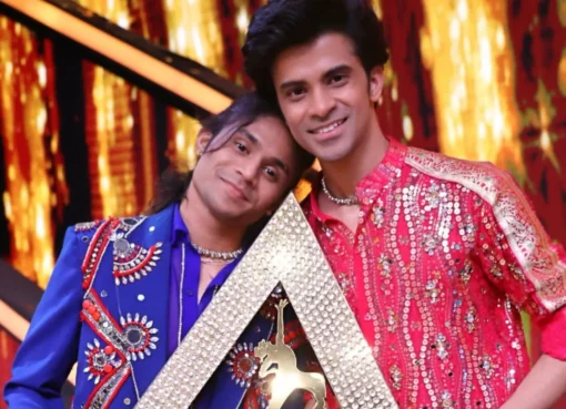 Ritesh Pal holding the India's Best Dancer trophy on stage.