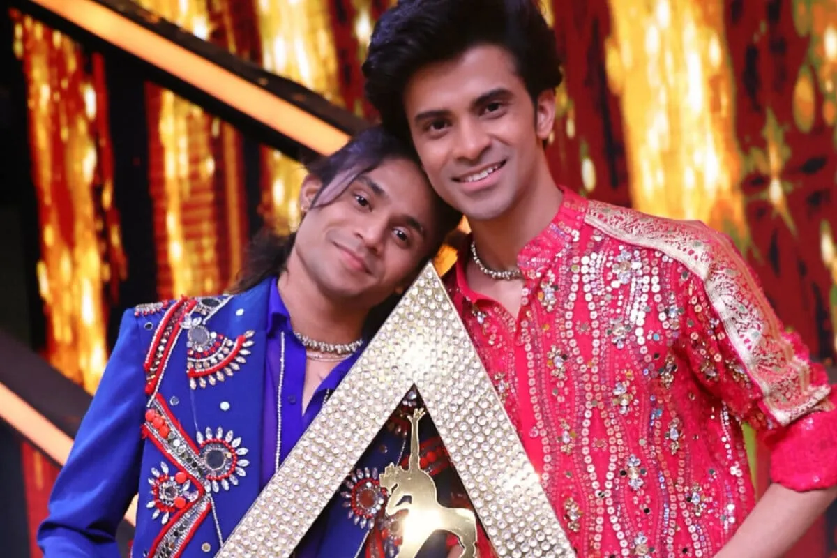 Ritesh Pal holding the India's Best Dancer trophy on stage.