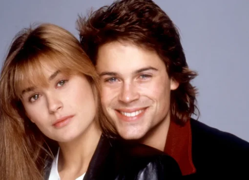 Rob Lowe smiling cheerfully during a TV interview.