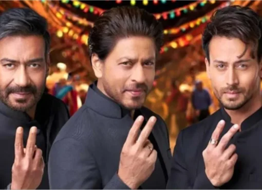 Shah Rukh Khan and Ajay Devgn at a public event looking serious.