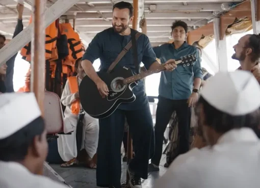 Saif Ali Khan playing a guitar on screen, looking cool and musical.